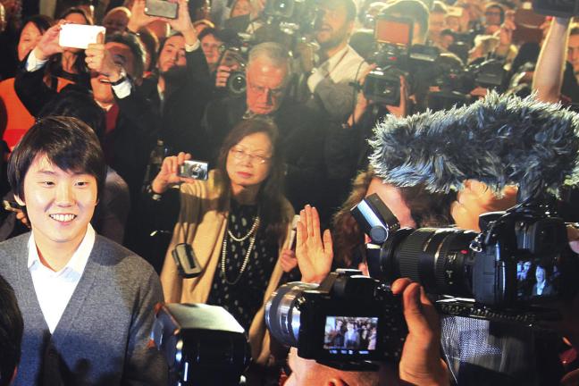 South Korean pianist Seong-Jin Cho, left, reacts after being named the winner of the 17th International Frederic Chopin Piano Competition in Warsaw, Poland, Tuesday, Oct. 20, 2015. (AP Photo/Czarek Sokolowski)